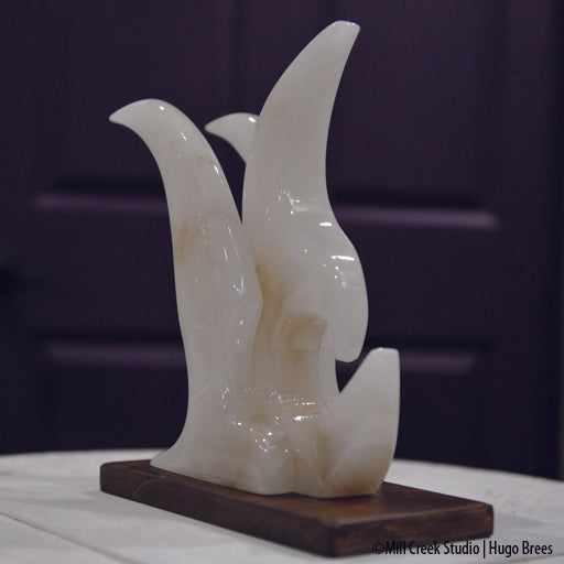 Contemporary lines grace this white Italian Alabaster bird sculpture.