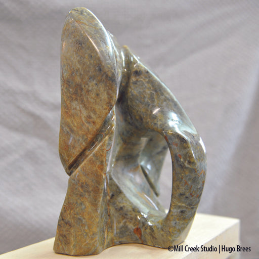 Brazilian Soapstone abstract sculpture in a medley of greens, golds, copper and black colours.