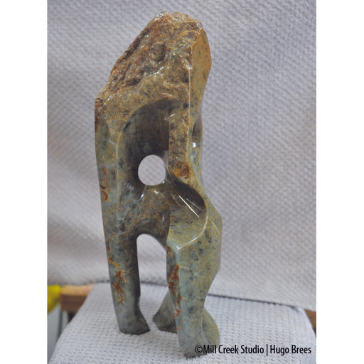 Upright Brazilian Soapstone Sculpture with mid-greens, copper and black mottling. Smooth and natural roughness to finish.