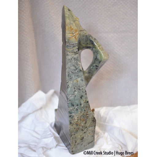 This blue-green Brazilian Soapstone with copper enhancements is shaped to arouse your curiosity.