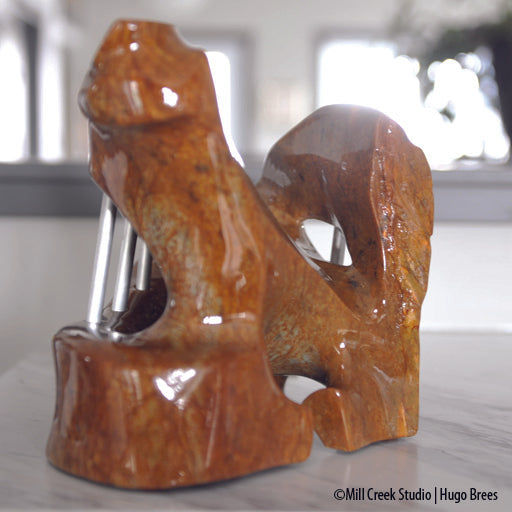 A shock of copper hued Brazilian Soapstone, the sculpture depicts the need for freedom from its captured form.