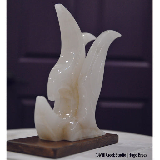 Contemporary lines grace this white Italian Alabaster bird sculpture.