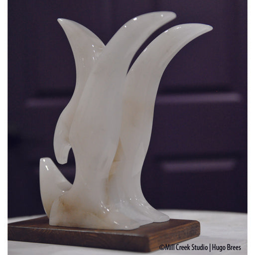 Contemporary lines grace this white Italian Alabaster bird sculpture.