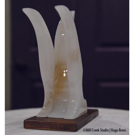 Contemporary lines grace this white Italian Alabaster bird sculpture.