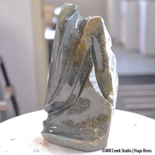 This abstract Brazilian Soapstone sculpture evokes a peaceful flow of colour on the smooth surfaces and a deviation to natural stone on the reverse.