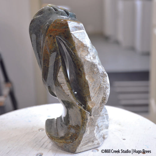 This abstract Brazilian Soapstone sculpture evokes a peaceful flow of colour on the smooth surfaces and a deviation to natural stone on the reverse.