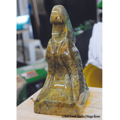 A solid sentinel for the yard/garden, this sculpture is a mix of green, copper, gold and black Brazilian Soapstone.